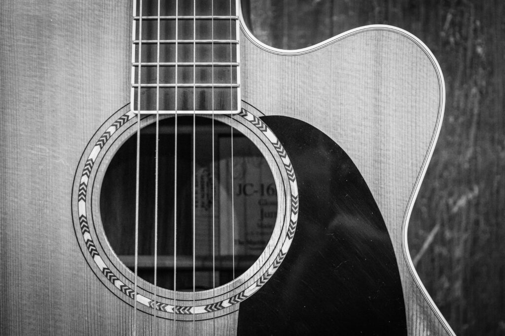 black and white picture of an acoustic guitar